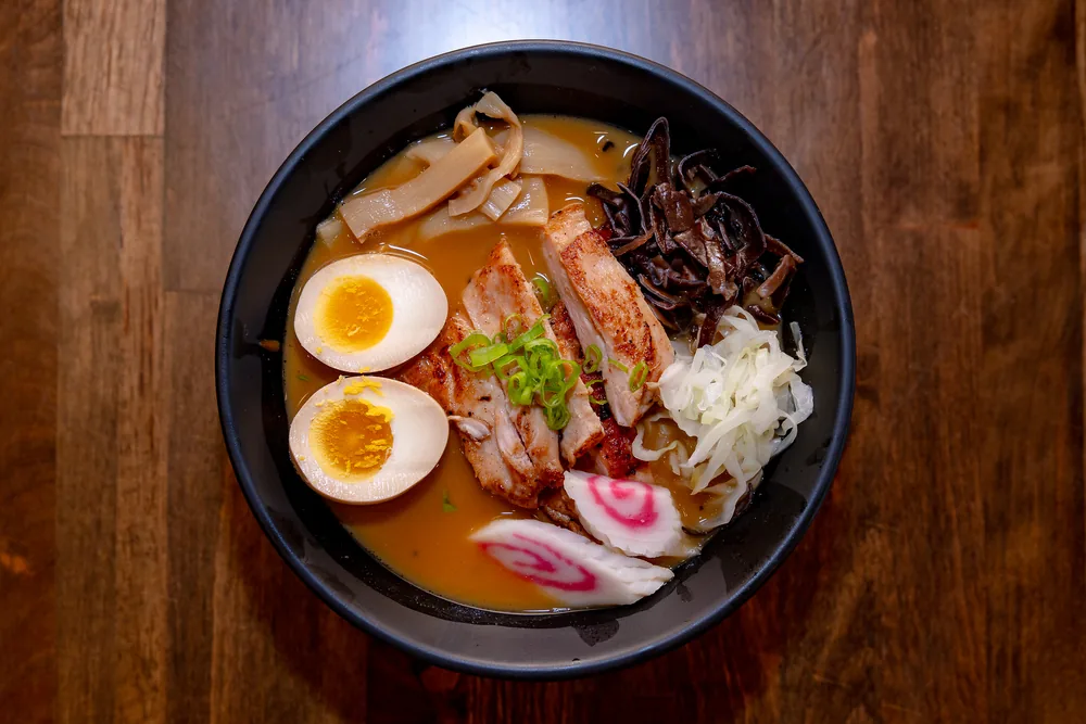 Ramen with seared sliced chicken, soft-boiled egg, bamboo and wood ear mushroom