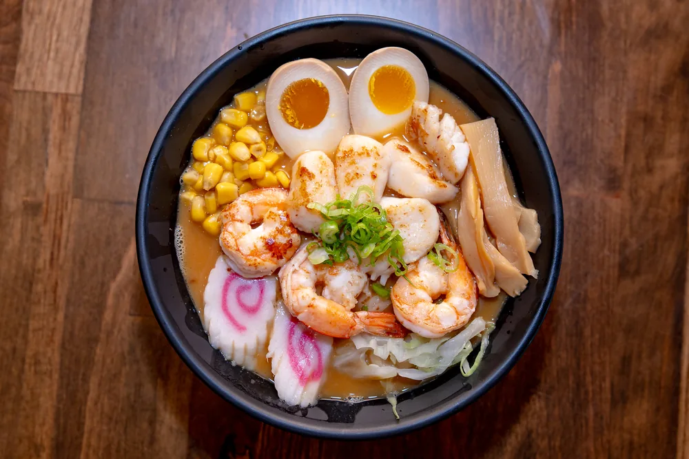 Seafood ramen with shrimp, scallops, corn, narutomaki and a soft-boiled egg